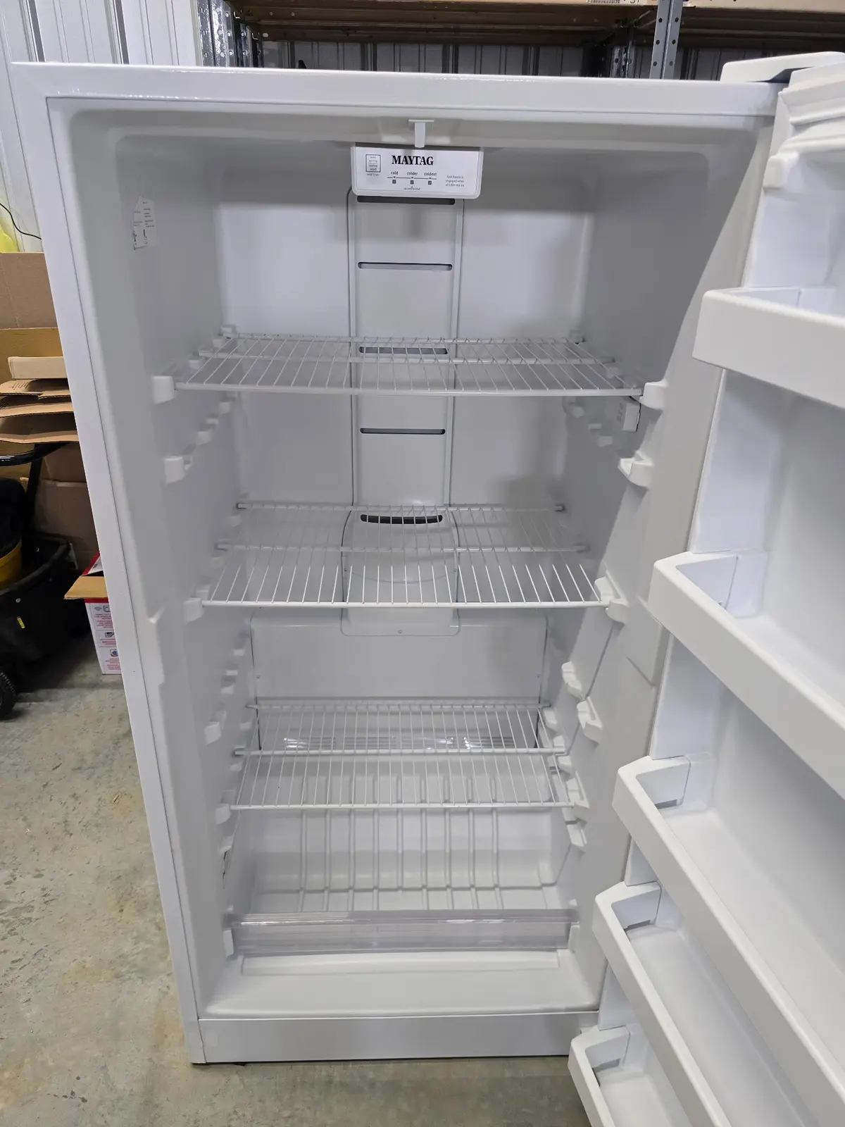 Clean freezer interior with adjustable wire shelves