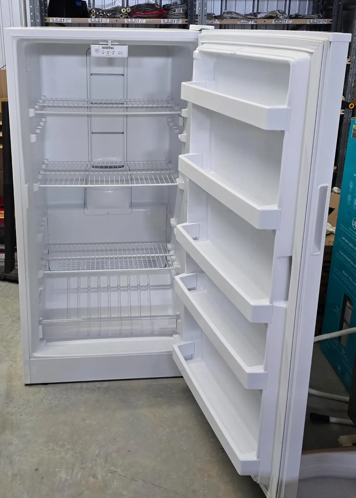Full open-door view showing clean interior and door storage